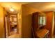 Hallway features wood paneling, wood floors, and bedroom access at 7240 Ottley St, Zephyrhills, FL 33541
