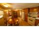Eat-in kitchen area with wood cabinets, laminate flooring, and white appliances at 7240 Ottley St, Zephyrhills, FL 33541