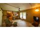 Open living space featuring retro wood paneling and a ceiling fan at 7240 Ottley St, Zephyrhills, FL 33541