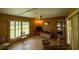Cozy living room with wood paneling, a ceiling fan, and natural light at 7240 Ottley St, Zephyrhills, FL 33541