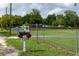 Unique tractor-shaped mailbox adds charm to the property's curb appeal, complemented by a spacious yard at 7240 Ottley St, Zephyrhills, FL 33541