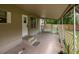 Enjoy outdoor living on this covered porch with swing and tile flooring at 7240 Ottley St, Zephyrhills, FL 33541
