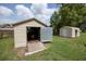 Exterior view of backyard sheds, offering convenient storage and workspace solutions on well-maintained green space at 7240 Ottley St, Zephyrhills, FL 33541
