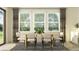 Elegant dining room featuring a wooden table, chairs, and large windows at 7519 E 117Th Ln, Palmetto, FL 34221