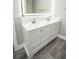 A spacious bathroom featuring double vanity with modern illuminated mirror at 913 Spindle Palm Way, Apollo Beach, FL 33572