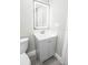Bathroom vanity with LED mirror and gray cabinets at 913 Spindle Palm Way, Apollo Beach, FL 33572