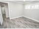 A bedroom features gray wood-look tile flooring, white trim and plantation shutters at 913 Spindle Palm Way, Apollo Beach, FL 33572