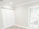 A well-lit bedroom features a large closet and bright window with shutters at 913 Spindle Palm Way, Apollo Beach, FL 33572