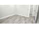 A bright bedroom features stylish gray wood-look tile flooring and white trim at 913 Spindle Palm Way, Apollo Beach, FL 33572