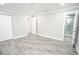 A bedroom featuring gray wood-look tile flooring and an ensuite bathroom at 913 Spindle Palm Way, Apollo Beach, FL 33572