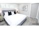 Neutrally decorated bedroom showcasing gray headboard, white bedding, and light-filled shutters at 913 Spindle Palm Way, Apollo Beach, FL 33572