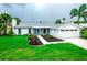 Charming single-story home with freshly landscaped yard, healthy green grass and an attached garage at 913 Spindle Palm Way, Apollo Beach, FL 33572