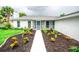 Charming home featuring a walkway through a beautifully landscaped front yard at 913 Spindle Palm Way, Apollo Beach, FL 33572