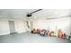 Clean, spacious garage with painted floors and ample storage space for equipment and tools at 913 Spindle Palm Way, Apollo Beach, FL 33572