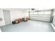 Spacious garage with an automatic door and clean painted floor at 913 Spindle Palm Way, Apollo Beach, FL 33572