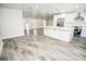Open concept kitchen features island, stainless steel appliances, and gray wood-look tile floors at 913 Spindle Palm Way, Apollo Beach, FL 33572