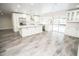 Open kitchen featuring white cabinetry, a large island, stainless steel appliances and poolside view at 913 Spindle Palm Way, Apollo Beach, FL 33572