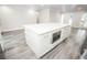 Kitchen island featuring white countertops and cabinetry, offering ample storage and counter space at 913 Spindle Palm Way, Apollo Beach, FL 33572