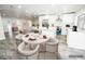 Bright, open kitchen with white cabinets, stainless appliances, and an island with breakfast bar seating at 913 Spindle Palm Way, Apollo Beach, FL 33572