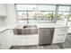 Modern kitchen sink overlooking the pool and canal offers a tranquil view for everyday tasks at 913 Spindle Palm Way, Apollo Beach, FL 33572