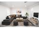 Spacious living room featuring neutral decor, a large sectional sofa and modern accents at 913 Spindle Palm Way, Apollo Beach, FL 33572