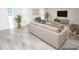 Open living room with wood look tile flooring, neutral furniture and plenty of natural light at 913 Spindle Palm Way, Apollo Beach, FL 33572