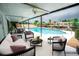 Spacious covered patio with waterfront views, plenty of seating, and access to the pool at 913 Spindle Palm Way, Apollo Beach, FL 33572