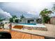 Stunning backyard featuring a pool and dock, offering seamless waterfront living and entertainment at 913 Spindle Palm Way, Apollo Beach, FL 33572
