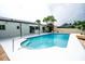 Inviting pool area surrounded by lush landscaping, creating a private and serene backyard oasis at 913 Spindle Palm Way, Apollo Beach, FL 33572