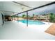 Relaxing covered patio area with a sparkling pool, perfect for outdoor entertaining and leisure at 913 Spindle Palm Way, Apollo Beach, FL 33572
