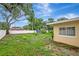 Backyard featuring the home, mature trees, and a full privacy fence at 963 27Th S Ave, St Petersburg, FL 33705