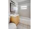 Bathroom features a tiled tub, yellow vanity with mosaic backsplash, and large mirror at 963 27Th S Ave, St Petersburg, FL 33705