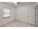 White tiled bedroom with single window and ceiling fan at 963 27Th S Ave, St Petersburg, FL 33705