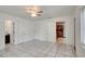 Spacious bedroom with tile flooring, ceiling fan, and multiple doorways at 963 27Th S Ave, St Petersburg, FL 33705