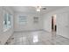 Bright bedroom with tile flooring, ceiling fan, and two windows at 963 27Th S Ave, St Petersburg, FL 33705