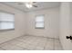 White tiled bedroom with dual windows and ceiling fan at 963 27Th S Ave, St Petersburg, FL 33705