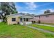 Charming single-story home with a well-manicured lawn and front porch, showcasing curb appeal at 963 27Th S Ave, St Petersburg, FL 33705