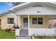 Welcoming front porch with brick accents, a storm door, and well-maintained landscaping at 963 27Th S Ave, St Petersburg, FL 33705