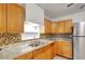 Close up view of traditional kitchen with light countertops, mosaic backsplash, and stainless steel refrigerator at 963 27Th S Ave, St Petersburg, FL 33705