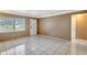 Bright living room with tile floors, featuring a large window and neutral wall colors at 963 27Th S Ave, St Petersburg, FL 33705