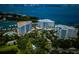 Stunning aerial view of waterfront condos with boat docks and lush landscaping with a city skyline in the background at 1 Seaside Ln # 302, Belleair, FL 33756