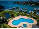 Scenic aerial view of the condominium complex, pool, and boat docks on the water at 1 Seaside Ln # 302, Belleair, FL 33756