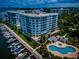 Luxury waterfront condominiums with community pool and boat docks on a sunny day at 1 Seaside Ln # 302, Belleair, FL 33756