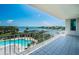 Balcony showcasing breathtaking waterfront view overlooking the marina, pool, and lush landscaping at 1 Seaside Ln # 302, Belleair, FL 33756