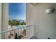 Balcony view showcasing a community pool, lush landscaping, and serene waterfront views on a sunny day at 1 Seaside Ln # 302, Belleair, FL 33756