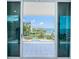 Balcony showcases waterfront views and a community pool accessible through large sliding glass doors at 1 Seaside Ln # 302, Belleair, FL 33756