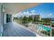 Balcony with a waterfront view overlooking a community pool and lush landscaping at 1 Seaside Ln # 302, Belleair, FL 33756