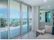 Balcony view showcasing waterfront and boats with large sliding glass doors into the living room space at 1 Seaside Ln # 302, Belleair, FL 33756