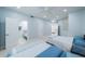 Bright bedroom featuring two beds, a ceiling fan, and an ensuite bathroom at 1 Seaside Ln # 302, Belleair, FL 33756