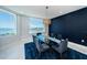 Elegant dining area showcasing a glass table, modern lighting, and captivating ocean views at 1 Seaside Ln # 302, Belleair, FL 33756